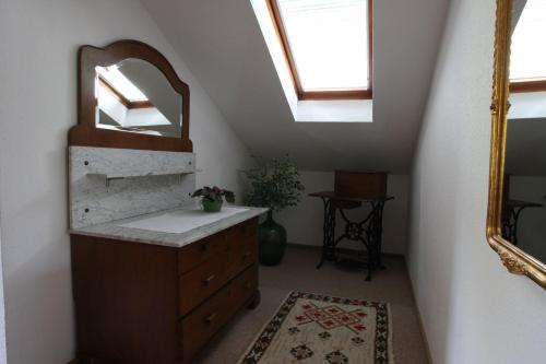 a bathroom with a sink and a mirror at Ferienwohnung Sobotta in Bad Reichenhall