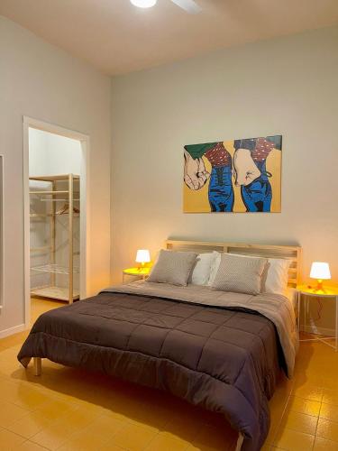 a bedroom with a bed with two paintings on the wall at amurimè in Porto Empedocle