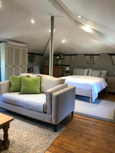 a bedroom with a bed and a couch and a bed at The Clockhouse in Old Windsor