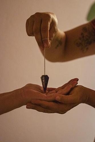 a person holding a small object in their hands at Gaia Hospedagem Holística in Brotas