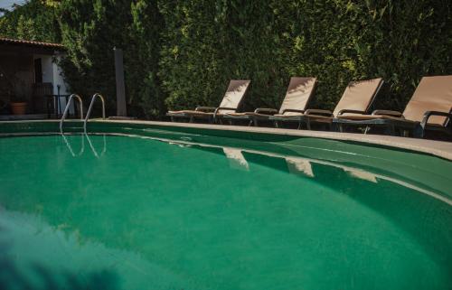 a group of chairs and a swimming pool at Casa de Marlães in Lousada