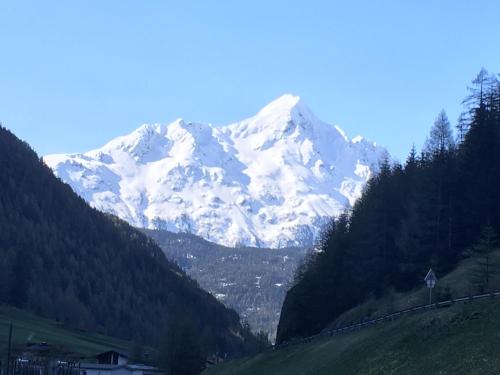 a snow covered mountain in the middle of a valley at Fremdenpension Alpenruhe in Sölden