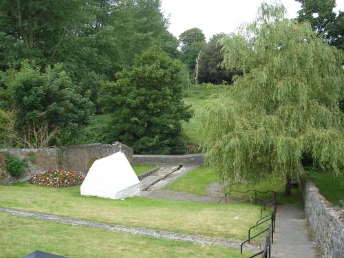 a garden with a white object in the grass at Twin Oaks Bed & Breakfast in Kilkenny