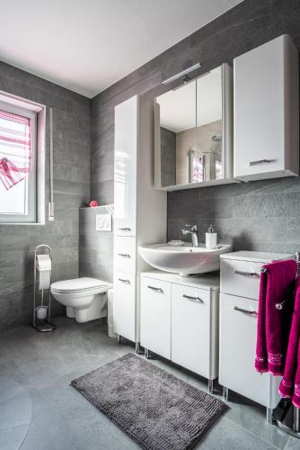 a bathroom with a sink and a toilet at Ferienwohnung Bichler in Altötting