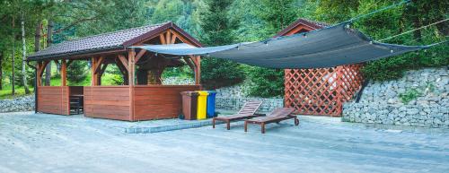 a gazebo with a bench and a hammock at Glamping Pod Gwiazdami Pietrusza Wola in Pietrusza Wola