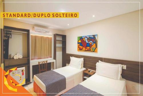 a room with two beds and a sign that reads standard drupal software at Netuanah Praia Hotel in João Pessoa
