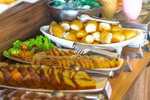 a buffet with many different types of food on a table at Netuanah Praia Hotel in João Pessoa