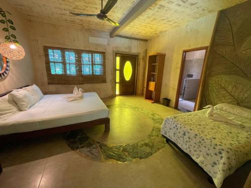 a bedroom with two beds in a room at Villas Adriana, Palenque in Palenque