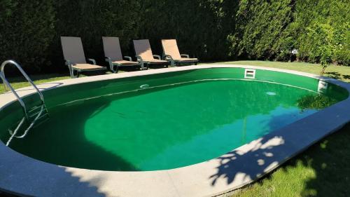 an empty swimming pool with chairs around it at Casa de Marlães in Lousada