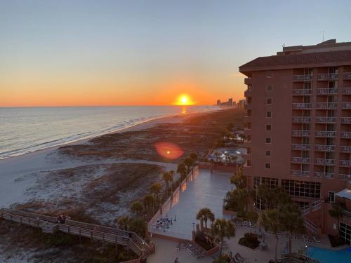 an aerial view of a hotel and the beach at sunset at Perdido Beach Resort in Orange Beach