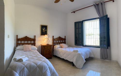 En eller flere senger på et rom på Casa Rural Finca de las Encarnaciones Bajas