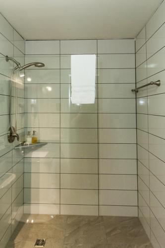 a shower with a glass door in a bathroom at Gingerbread House Inn - We Are Open - Winter, Spring, Summer and Fall in Wolfville