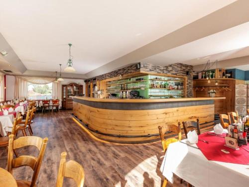 a restaurant with tables and chairs and a bar at Gästehaus Angerer in Reit im Winkl
