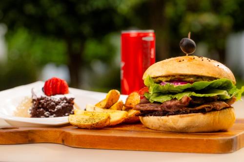 a plate of food with a sandwich and french fries at Hotel Horizon & Convention Center in Morelia