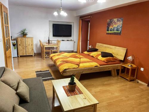 a bedroom with a bed and a living room at Pension U Kohoutů in Horní Planá