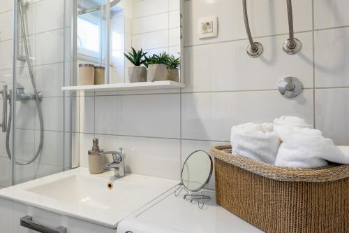 a bathroom with a sink and a mirror at Apartman Olive in Supetar
