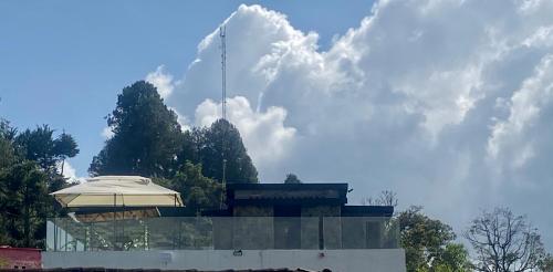 a building with an umbrella on top of it at BERAKHAH SPA & ROOMS in Guatapé