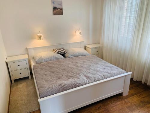 A bed or beds in a room at Apartmán Lesníček