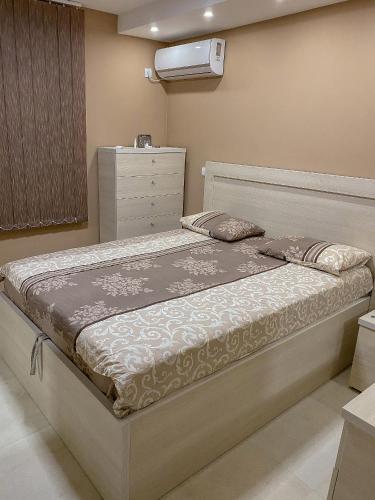 a bedroom with a large bed with a dresser at Apartments Piano in Utjeha