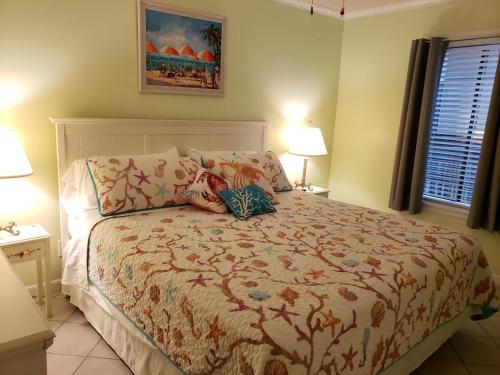 a bedroom with a bed and two lamps and a window at A Place at the Beach 406 in Myrtle Beach
