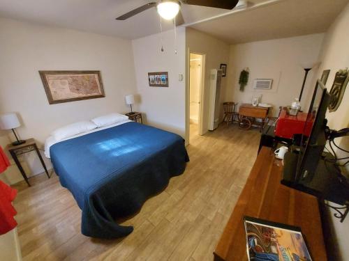 a bedroom with a bed with a blue blanket on it at Cactus Inn in McLean