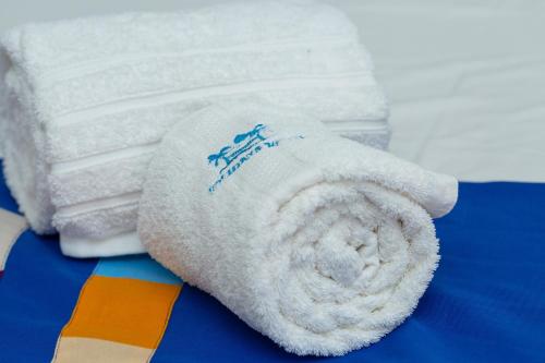 a stack of towels sitting on top of a table at Holidays Hotel in Mahajanga