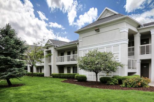 a large white building with a green yard at Studio 6 - Murray, UT in Murray