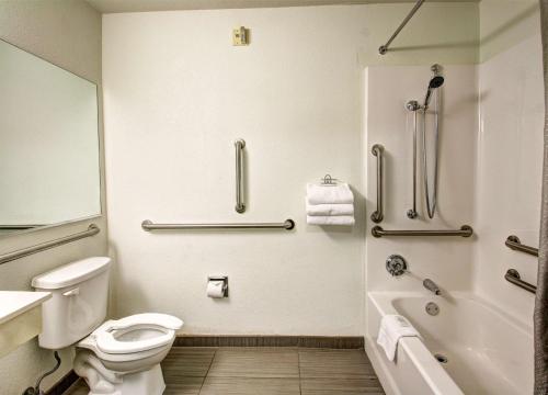 a bathroom with a toilet and a tub and a sink at Studio 6-Murray, UT - Salt Lake City - Fort Union in Murray