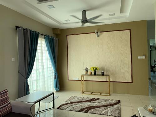 a living room with a large screen on the wall at VISTANA INDAH HOMESTAY in Alor Setar