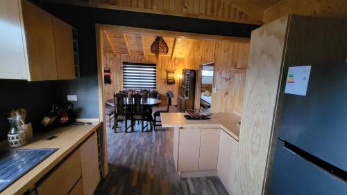 a kitchen and dining room with a table and chairs at CABAÑA DE CAMPO in Cuncumén