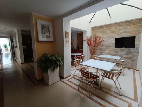a dining room and living room with a table and chairs at Hotel Boutique Confort Suites in Popayan