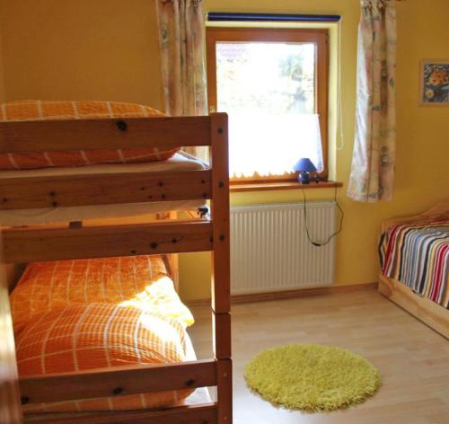 a bedroom with two bunk beds and a window at Ferienwohnung Herold in Wessobrunn