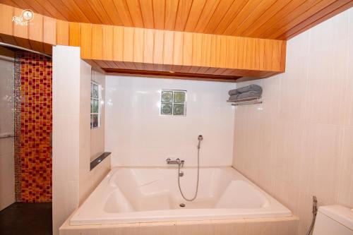 a bath tub in a bathroom with a wooden ceiling at Krabi Resort- SHA Extra Plus in Ao Nang Beach