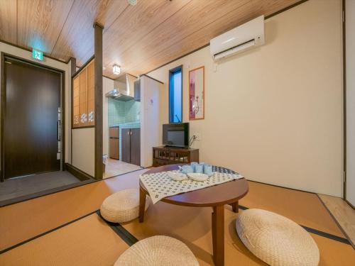 a living room with a table and two chairs at YADOYA Matsugaya in Tokyo