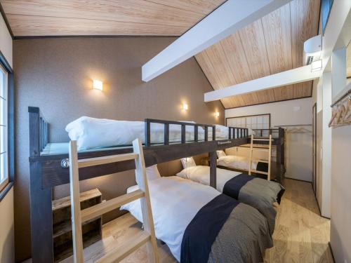 a room with two bunk beds in a room at YADOYA Matsugaya in Tokyo
