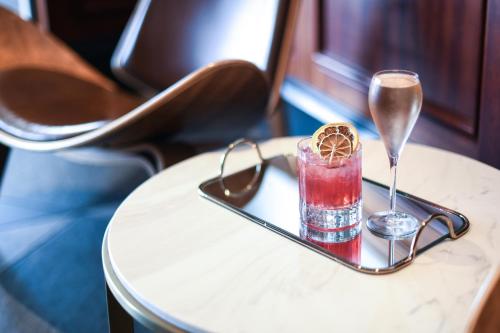 a tray with a drink and glasses on a table at Powerhouse Hotel Tamworth by Rydges in Tamworth