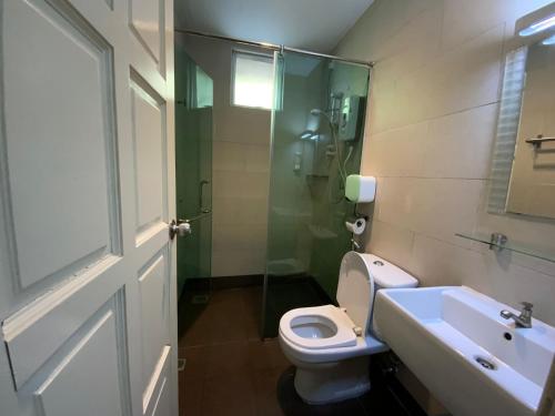 a bathroom with a toilet and a sink and a shower at Highlanders Garden Guesthouse at Arundina Cameron Highlands in Cameron Highlands