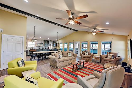 a living room with couches and a table at Copano Ridge Dream A in Rockport