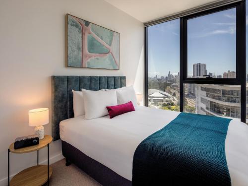 a bedroom with a large bed and a large window at The Star Residences - Gold Coast in Gold Coast