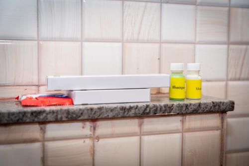 two bottles of essential oils sitting on a counter at Hotel Dhruv Palace Bangalore Jakkur in Bengaluru