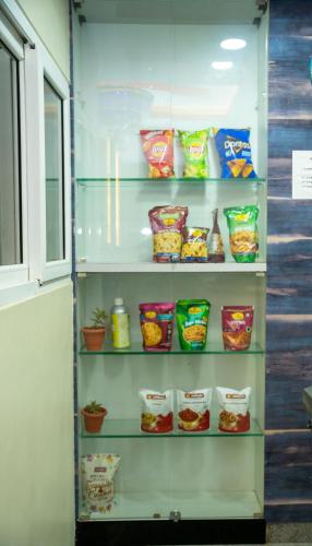 a refrigerator filled with lots of food at Hotel Dhruv Palace Bangalore Jakkur in Bengaluru