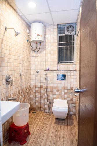 a bathroom with a toilet and a sink and a shower at Hotel Dhruv Palace Bangalore Jakkur in Bengaluru