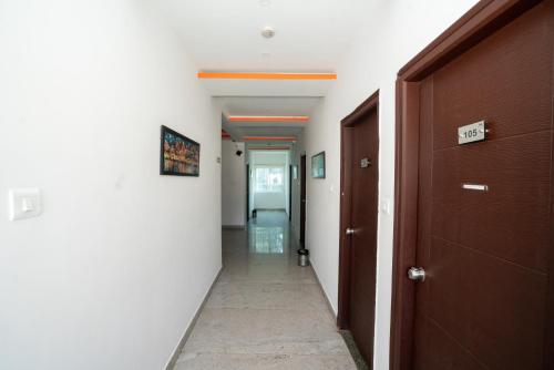 a corridor of a hallway with a door and a hallway at Hotel Dhruv Palace Bangalore Jakkur in Bengaluru