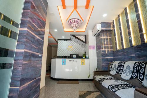 a room with two couches and a bar in it at Hotel Dhruv Palace Bangalore Jakkur in Bengaluru