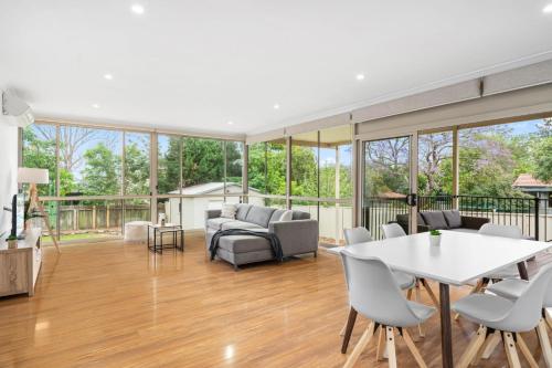a living room with a table and chairs at Big Stylish 3 bed house with Free Parking in Oatlands