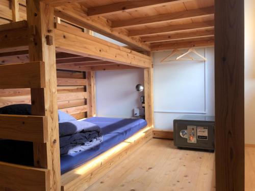 a bedroom with a bunk bed and a tv at HIKE in Tamana