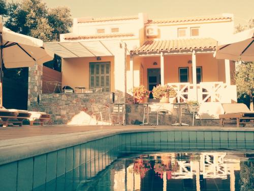 a house with a swimming pool in front of a house at Sea Sun in Plomarion
