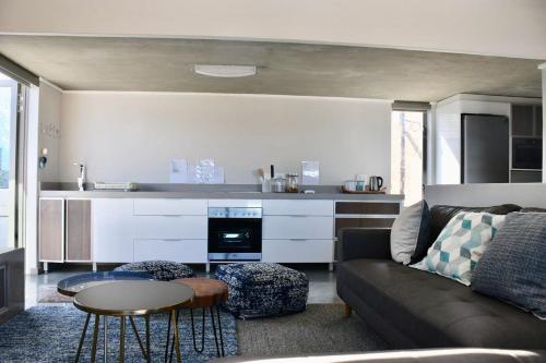 a living room with a couch and a table at At Last Glentana Apartment in Groot Brak Rivier
