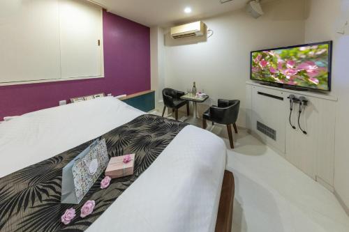 a hospital room with a bed and a flat screen tv at Hotel ＧEM - Adult Only in Sendai