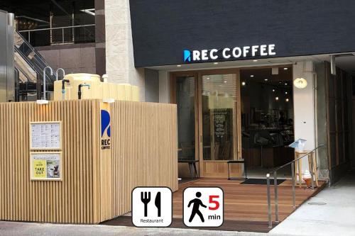 a facade of a store with signs in front of it at goom Hotel Nakasu in Fukuoka